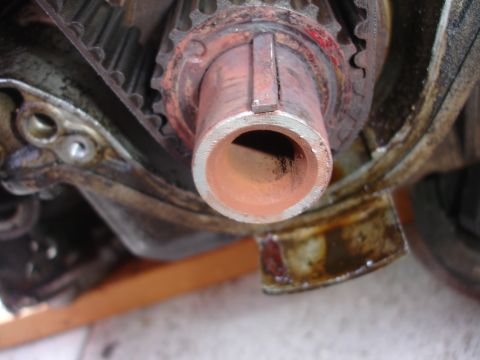 1993 Ford Taurus - Close-up of a rusty engine component with a timing belt.