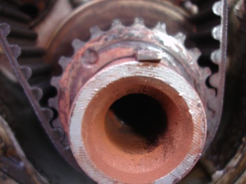 1993 Ford Taurus - A detailed view of a vehicle's engine timing belt and pulley mechanism, showing wear and rust.