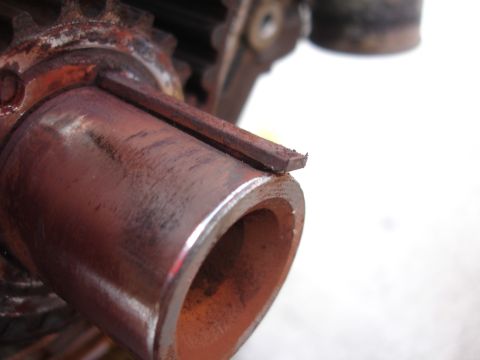 1993 Ford Taurus - Close-up view of a rusty metal component a prominent keyway.