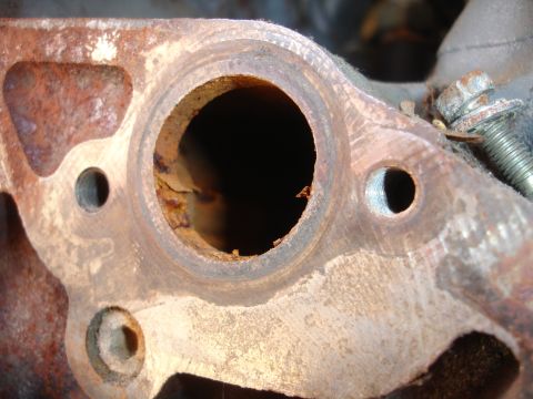 1993 Ford Taurus - A corroded engine part shows significant rust and wear.