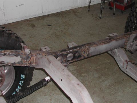 1948 Jeep Wrangler - Close-up of a vehicle frame undergoing repair work.