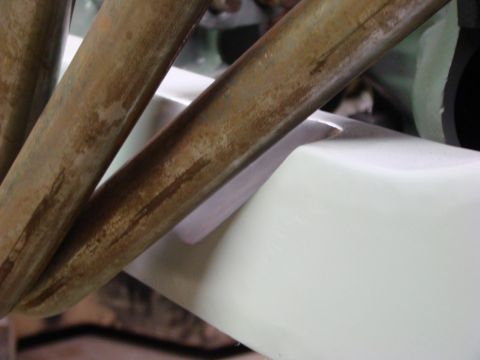 1948 Jeep Wrangler - Close-up view of exhaust pipes positioned above a white frame component, with a Supermotors.net watermark visible.