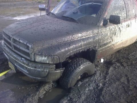 1996 Dodge 1500 - This 1996 Dodge 1500 is deeply stuck in the mud, with its front tire submerged.