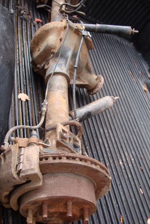 1996 Ford Bronco - A rusty rear axle assembly, likely from a truck or SUV, is shown in a truck bed.
