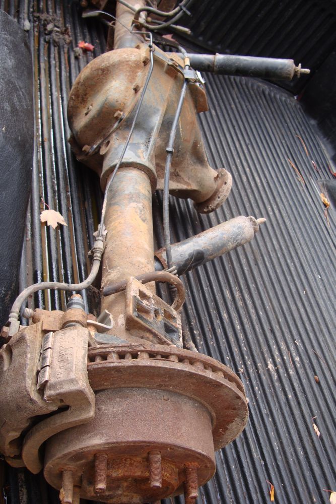 Rear axle assembly with disc brake rotor and caliper