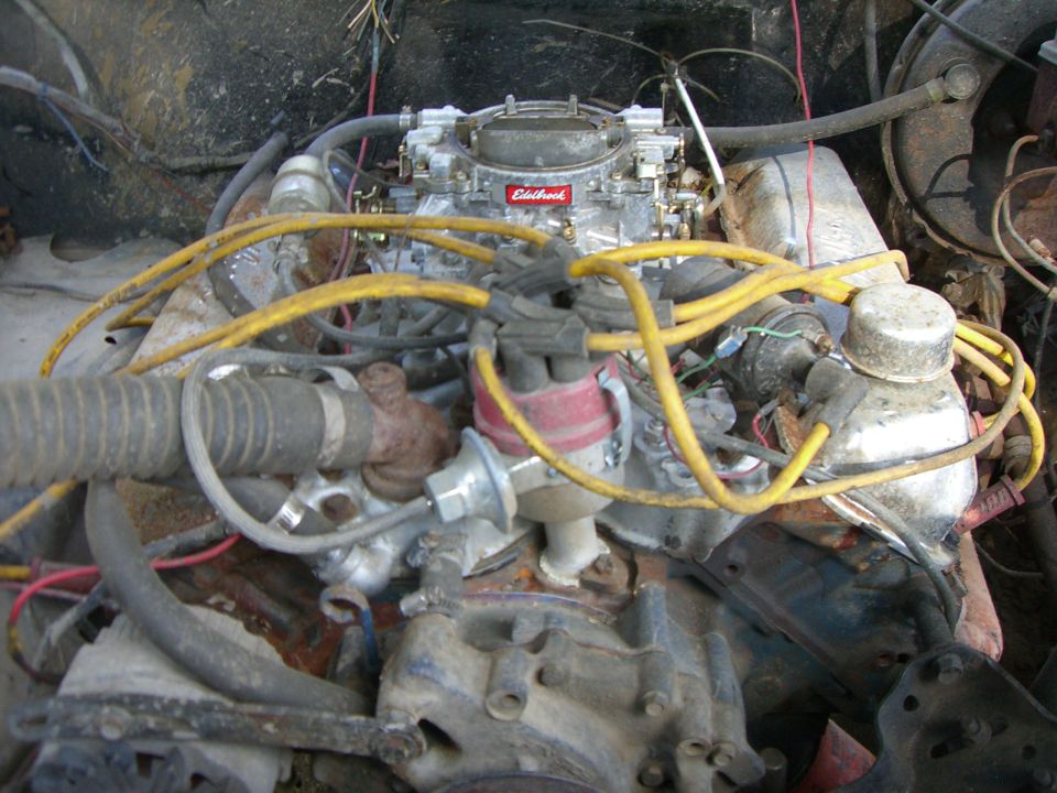 Engine bay with Edelbrock carburetor and yellow spark plug wires
