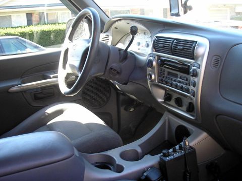 2002 Ford Sport Trac - The interior of a 2002 Ford Sport Trac is captured, highlighting the driver's side controls and dashboard.
