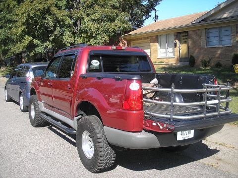 2002 Ford Sport Trac - This 2002 Ford Sport Trac is seen from the rear, a bed extender and a second vehicle parked closely behind.
