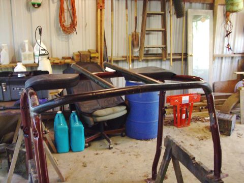 1995 Ford Bronco - A custom roll cage is visible in a cluttered garage setting.