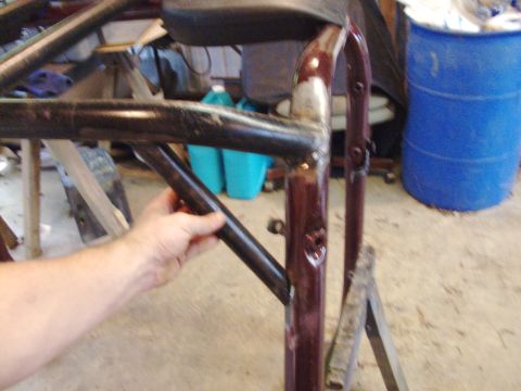 1995 Ford Bronco - Close-up of a metal tube being held, part of a roll cage assembly.