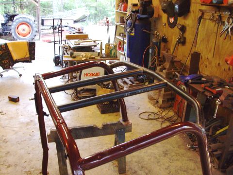 1995 Ford Bronco - Custom roll cage fabrication in progress inside a workshop setting.