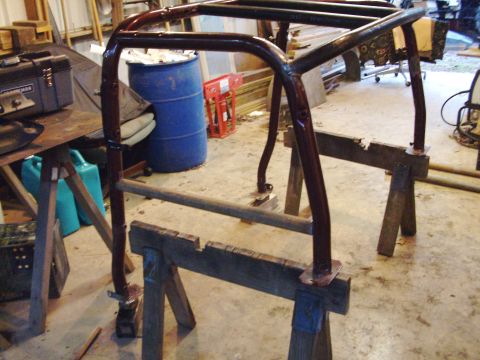1995 Ford Bronco - A custom-built roll cage is shown mounted on sawhorses, likely in a garage or workshop setting.