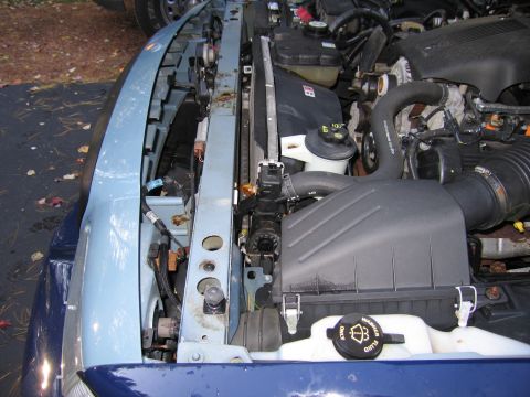 1991 Ford LTD Crown Victoria - Close-up of a vehicle's engine bay, focusing on the radiator and air intake system.
