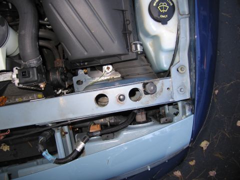 1991 Ford LTD Crown Victoria - The engine bay of a car, with various components visible, including the air filter housing and washer fluid reservoir.