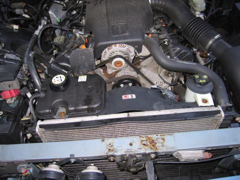 1991 Ford LTD Crown Victoria - Close-up view of a V8 engine bay, showing the radiator, fan, and various hoses and components.