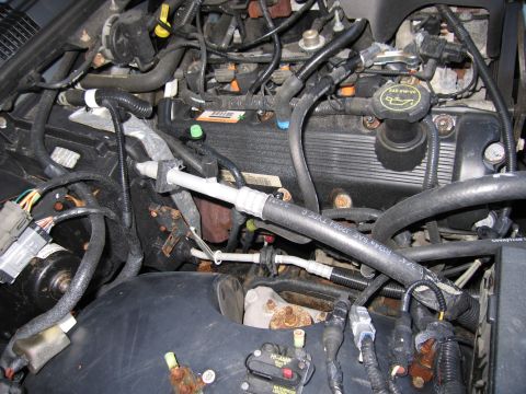 1991 Ford LTD Crown Victoria - The engine bay of a vehicle, showing various components and wiring harnesses.