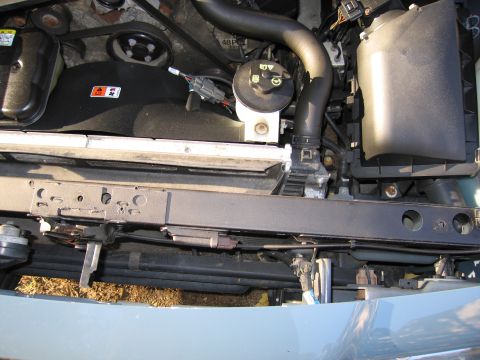 1991 Ford LTD Crown Victoria - Close-up view of a vehicle's engine bay, showing various components and the radiator.