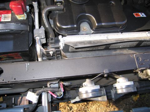 1991 Ford LTD Crown Victoria - Close-up view of car engine components including the battery, radiator, and horns.