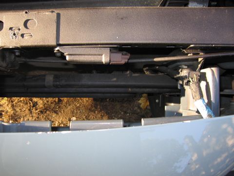 1991 Ford LTD Crown Victoria - A close-up view of the front underside of a vehicle, showing the bumper and internal components.