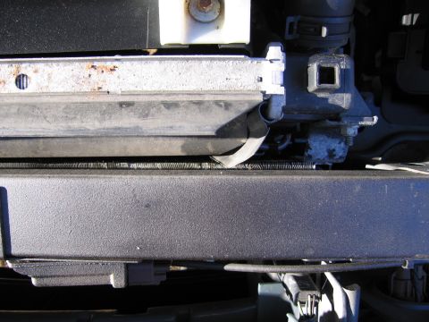 1991 Ford LTD Crown Victoria - A close-up view of a vehicle's radiator and surrounding engine components.