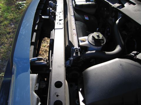 1991 Ford LTD Crown Victoria - Close-up view of a vehicle's engine bay, showing various components and the radiator.