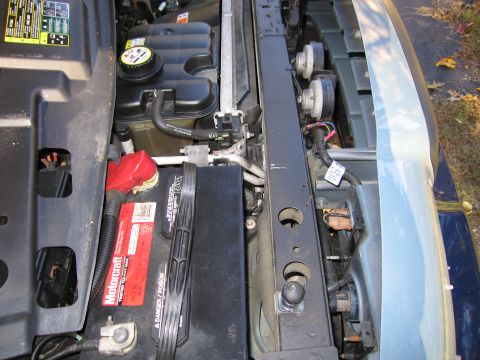 1991 Ford LTD Crown Victoria - The engine bay shows a Motorcraft battery and radiator. The registry claims this is a 1991 Ford Crown Victoria LTD, but visual evidence is…