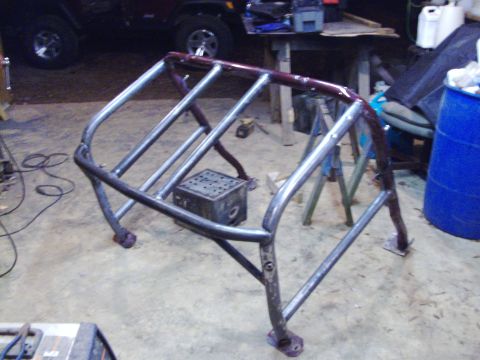 1995 Ford Bronco - Custom roll cage frame, likely for off-road use, in a workshop setting.
