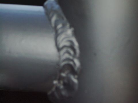 1995 Ford Bronco - A close-up view of a metal tube with visible weld marks, suggesting it's a custom or repaired part.