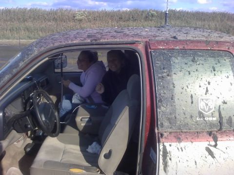 1996 Dodge 1500 - Two young women are inside a muddy 1996 Dodge 1500 pickup truck, ready for some off-roading.