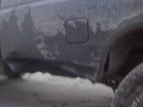 1996 Dodge 1500 - The lower body panel of a truck shows signs of rust and wear.