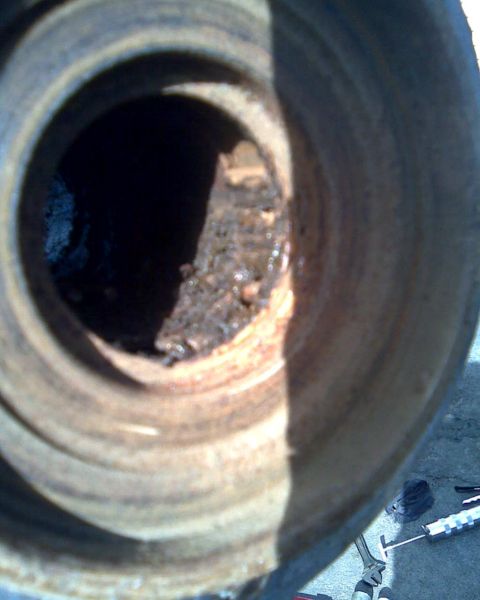1989 Ford Bronco - A close-up view of a damaged wheel and tire assembly.