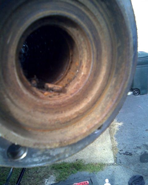 1989 Ford Bronco - This image shows a heavily rusted metal component, likely a part from a vehicle, with significant internal corrosion and debris.