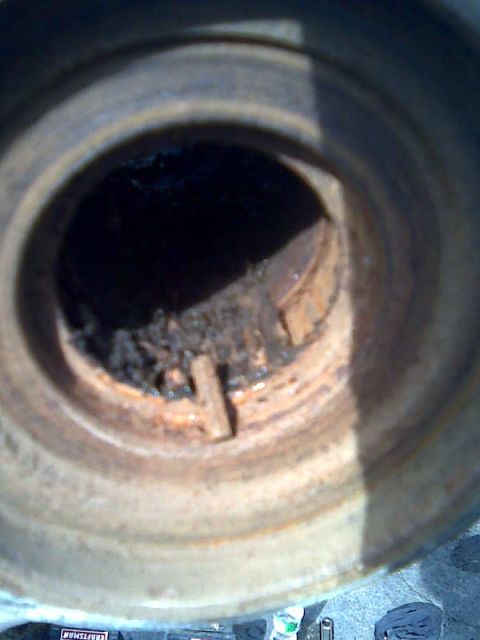 1989 Ford Bronco - Rusted brake rotor with debris inside, likely from a vehicle part.