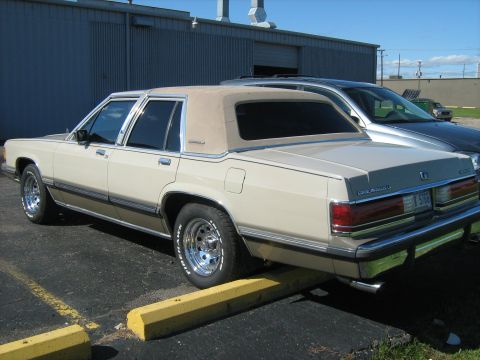 1988 Mercury Grand Marquis - Rear view of a 1988 Mercury Grand Marquis, showing its distinctive two-tone tan and brown paint scheme.