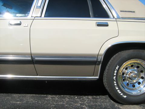 1988 Mercury Grand Marquis - A side view of a 1988 Mercury Grand Marquis shows its two-tone paint and chrome trim.