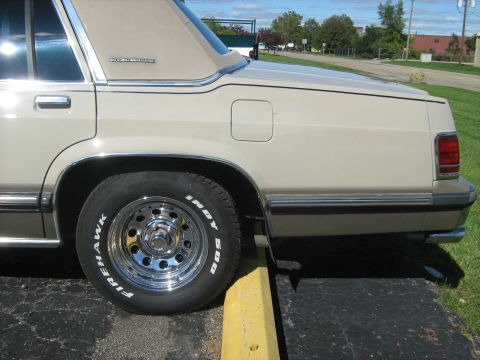1988 Mercury Grand Marquis - Rear quarter panel and wheel of a 1988 Mercury Grand Marquis, chrome wheels and Firehawk Indy 500 tires.