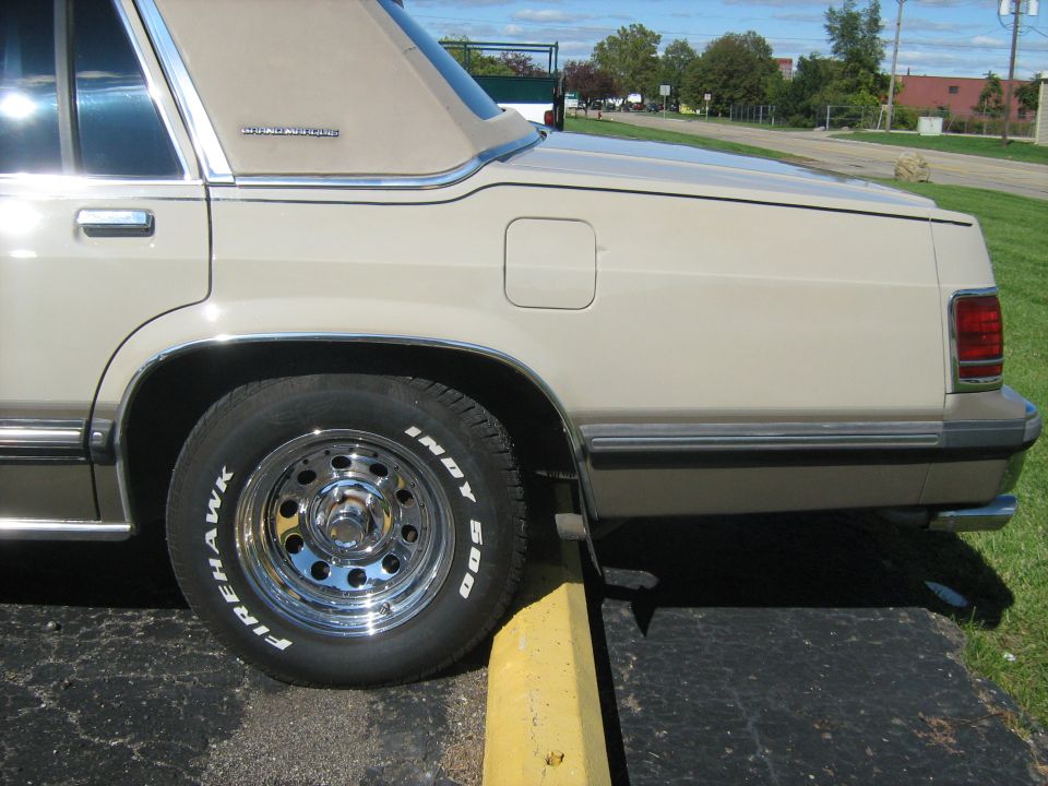 1988 Mercury Grand Marquis side view, tan with chrome wheels and Firehawk Indy 500 tires