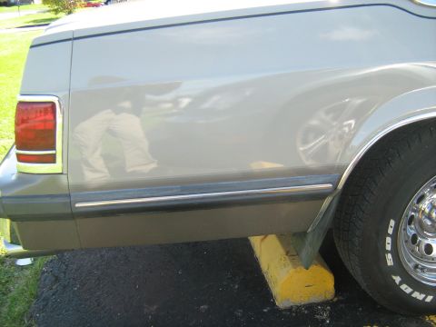 1988 Mercury Grand Marquis - Rear view of a 1988 Mercury Grand Marquis, showing the taillight and quarter panel detail.