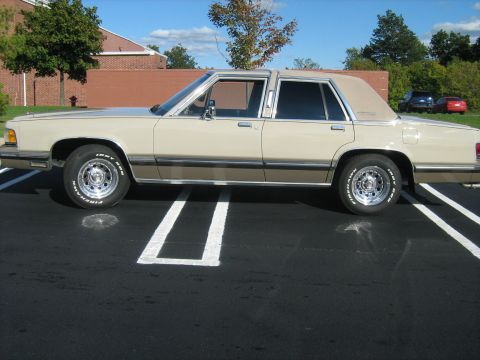 1988 Mercury Grand Marquis - Side profile of a 1988 Mercury Grand Marquis sedan parked in a lot.