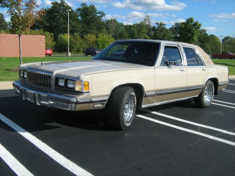 1988 Mercury Grand Marquis - This 1988 Mercury Grand Marquis sedan is parked in a lot under a cloudy sky.