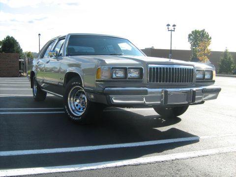 1988 Mercury Grand Marquis - A 1988 Mercury Grand Marquis is shown from the front three-quarter view in a parking lot.
