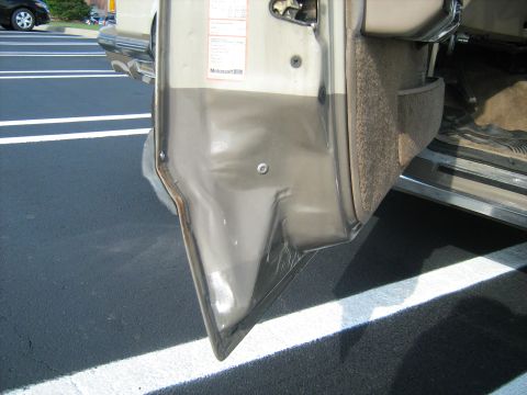 1988 Mercury Grand Marquis - The interior door panel shows damage, with a black car visible through the open door.