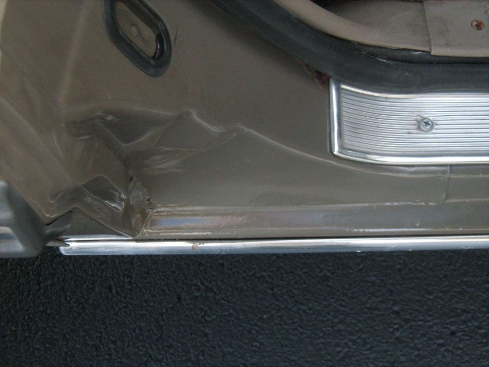 Damaged interior door panel and rocker panel on a car