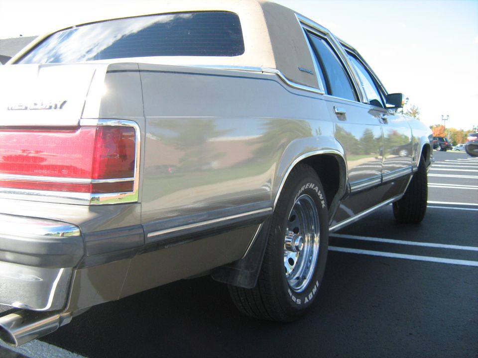 1988 Mercury Grand Marquis rear quarter panel and wheel, tan vinyl top