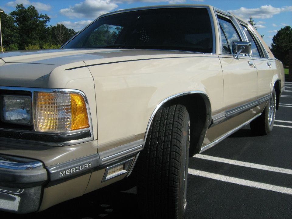 Front quarter view of a tan 1988 Mercury Grand Marquis parked in a lot