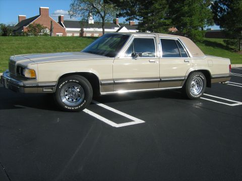 1988 Mercury Grand Marquis - This 1988 Mercury Grand Marquis sedan is seen from the side, a tan exterior with a contrasting vinyl top.