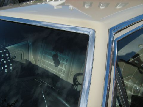 1988 Mercury Grand Marquis - The interior of a car is visible through the windows, with a reflection of the steering wheel on the windshield.
