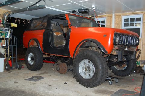 1994 Ford Bronco - This lifted International Harvester Scout II is undergoing work in a garage, showing its off-road modifications.