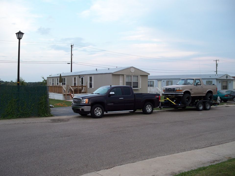 Tan 1992 Ford Bronco on trailer, 3q-front view