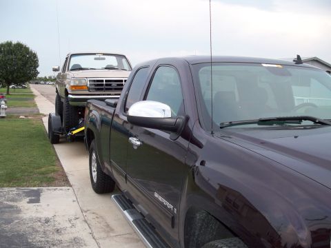 1996 Ford Bronco - A 1992 Ford F-Series pickup truck is being towed on a trailer by another pickup truck.